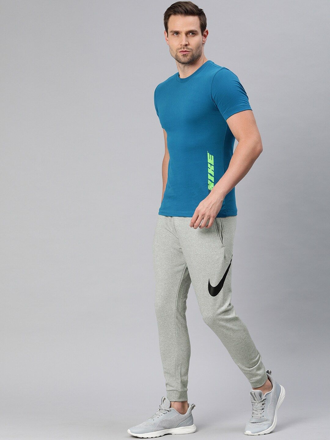  Nike Men Grey Solid Dri-FIT M NK Tapered Fit Training Joggers With Printed Detailing